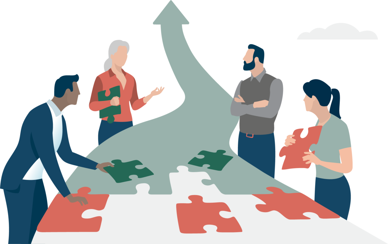 Ein Team aus vier Personen baut mit großen Puzzlesteinen einen Pfeil nach oben